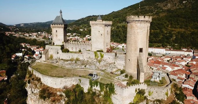 Aerial view of impressive medieval castle on rocky outcrop in French commune of Foix
