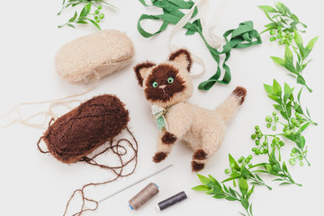 knitted siamese cat on a white background