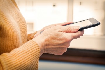 senior woman holding a digital tablet or laptop