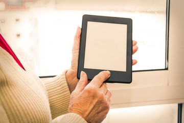 senior woman holding a digital tablet or laptop