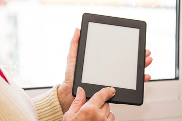 senior woman holding a digital tablet or laptop