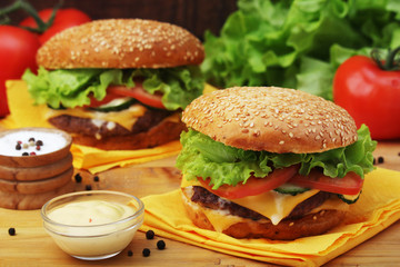 Two fresh hamburgers with vegetables