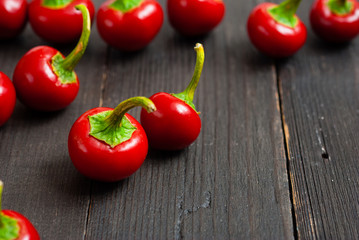 cherry peppers on old black wooden table background