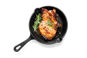 Fried pork steak in frying pan  isolated on white background. 