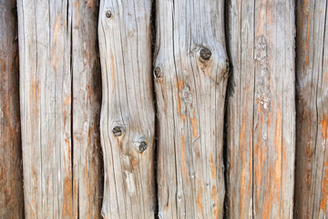 background of hewn logs. texture of the old logs with cracks and knots 