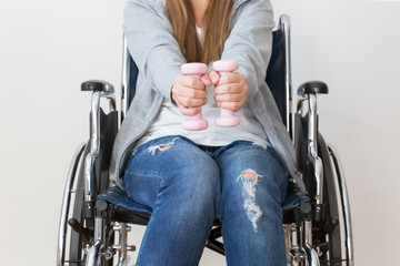 Disabled woman exercising with dumbells.