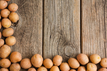 petite potatoes on rustic wood table background