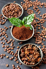 Coffee beans and ground powder on stone background. Top view