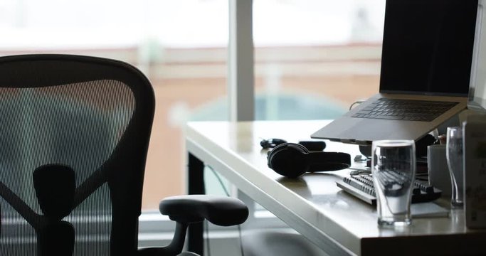 Trandy office desk next to large window - startup software development