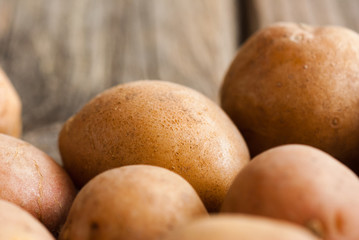 petite potatoes on rustic wood table background