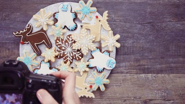Flat lay. Food photographer photographing Christmas cookies with professional digital camera.