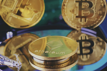 Virtual Cryptocurrency and Blockchain Technology concept, golden bitcoin on dismantle hard disk over gently lit dark background and light ray
