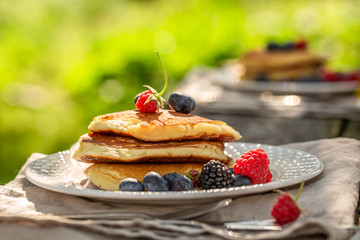 Sweet pancakes with fresh blueberries and honey