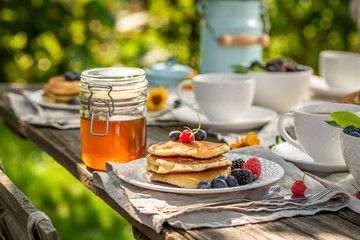 Sweet pancakes served with coffee in garden