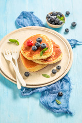 Sweet american pancakes with fresh blueberries and sugar