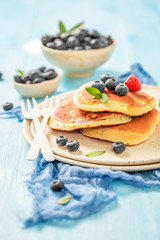 American pancakes for breakfast in the morning on blue table