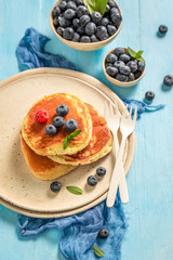 Tasty american pancakes for breakfast on blue table