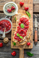 Closeup of homemade sandwich with fresh cherry jam