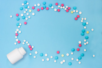 Multi-colored pills on a blue background