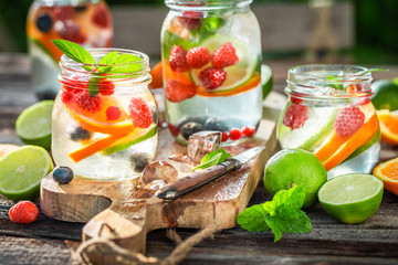 Fresh lemonade with mix of fruits in sunny day