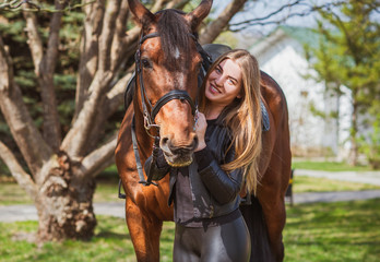 Spring - summer season, concept of hobby, Woman with a horse on a nature, relationship human and...