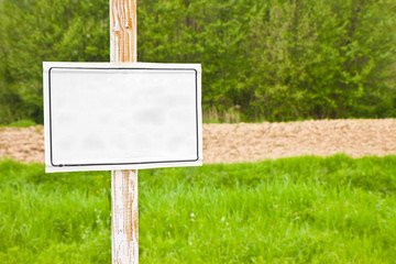 Wooden blank sign indicating in the countryside - image with copy space