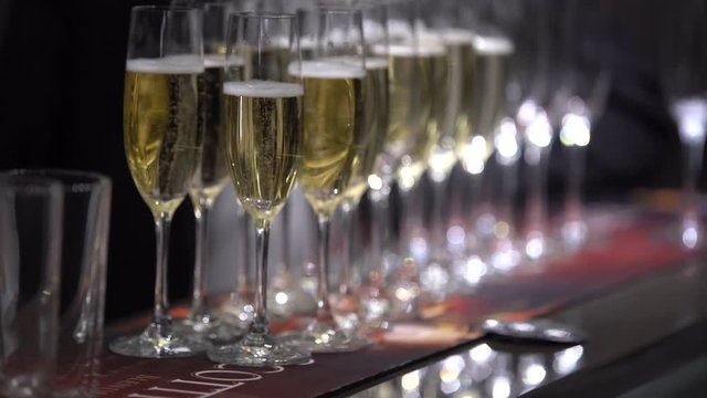 On the table are empty glasses and glasses of champagne,focus on empty glasses,then focus on full glasses, close-up