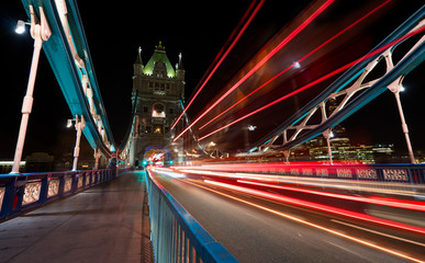 Fototapeta na wymiar Light trails produced by busses and cars on the Tower Bridge in London.
