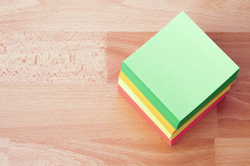 A stack of paper for notes of different colors.