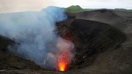 Stunning shot of an active volcano spewing out glowing lava high in the air. © helivideo