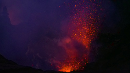 CLOSE UP: Dangerous volcanic eruption spewing lava from the depths of a crater.
