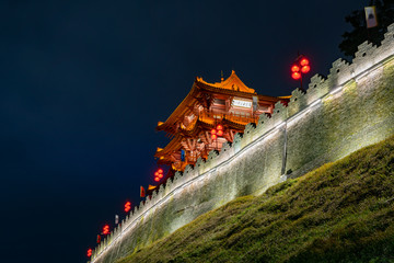 Fototapeta na wymiar Night view of the Zhaoqing Ancient City Wall with Pi Yun Lou building