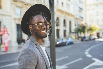 Fototapeta premium Handsome African American guy portrait smiling with style on the street