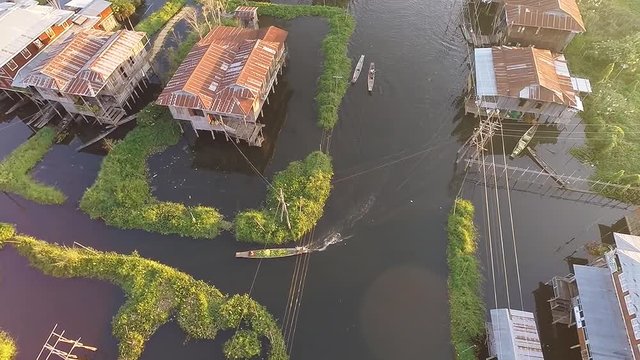 TAUNGGYI, MYANMAR. Aerial drone shot of the rows of colourful stilt houses on Inle Lake. Panorama of the big floating village.