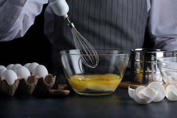 mixer and dough. recipe of pie or cake concept on dark