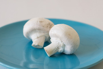 Champignon mushrooms fresh raw vegetarian food on table white background