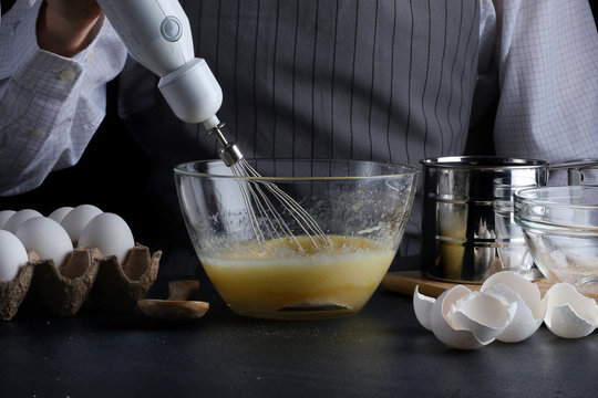 Chef With Mixer In Hands Cooking Pie With Ingridients On Table