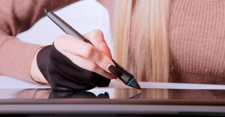 Close up female graphic designer working on digital tablet.