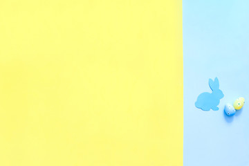 Paper Easter Bunny on yellow and blue background.