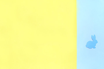 Paper Easter Bunny on yellow and blue background.