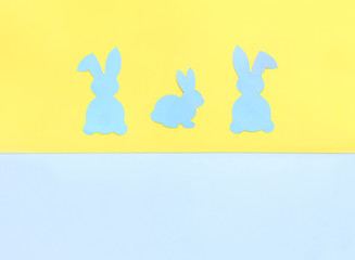 Paper Easter Bunny on yellow and blue background.