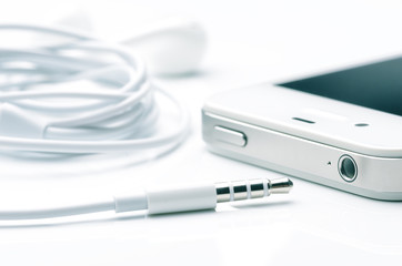 headphone jack or phone connector or audio jack with smartphone on white background