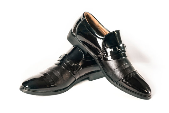 Elegant black men's lacquered shoes on a white background