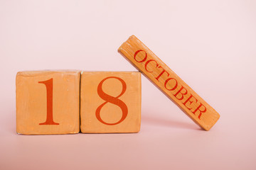 october 18th. Day 18 of month, handmade wood calendar  on modern color background. autumn month, day of the year concept