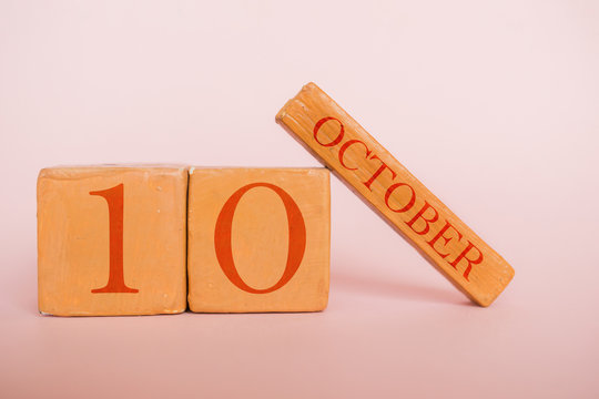 october 10th. Day 10 of month, handmade wood calendar  on modern color background. autumn month, day of the year concept