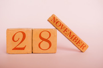 november 28th. Day 28 of month, handmade wood calendar  on modern color background. autumn month, day of the year concept