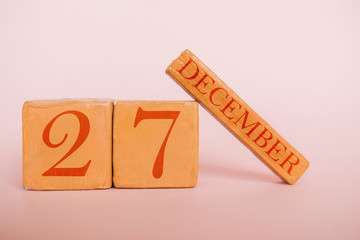 december 27th. Day 27 of month, handmade wood calendar  on modern color background. winter month, day of the year concept