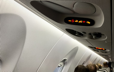 Fototapeta premium Flugzeug Passagierkabine Leuchtzeichen