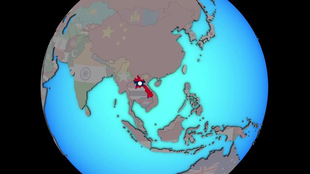 Closing in on Laos with embedded national flag on blue political 3D globe. 3D illustration.