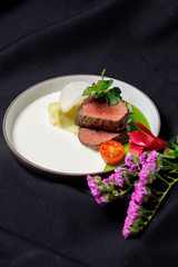 Beef tenderloin with cream sauce and green butter.
